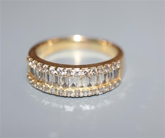 A modern 18k yellow metal and channel set baguette cut diamond set half hoop ring, with brilliant set borders, size M.